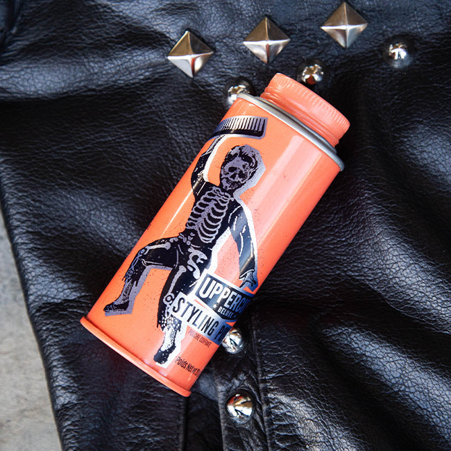 Skull Dust Styling Powder on a leather jacket with studs