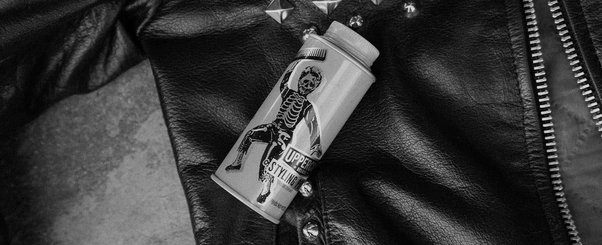 Skull Dust Styling Powder on a leather jacket with studs