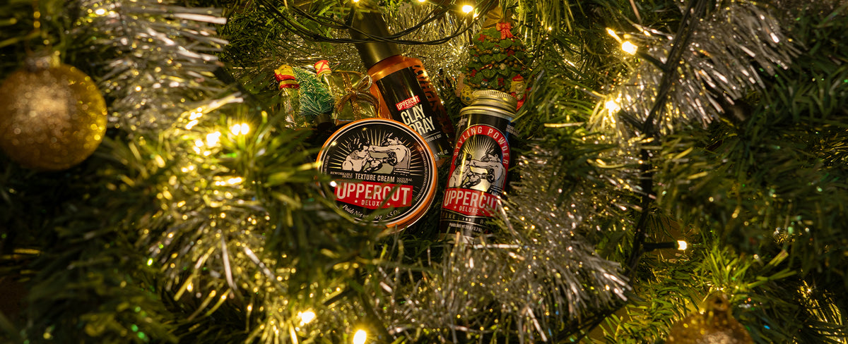 Uppercut Deluxe products placed inside a Christmas tree, surrounded by decorations and Christmas lights.