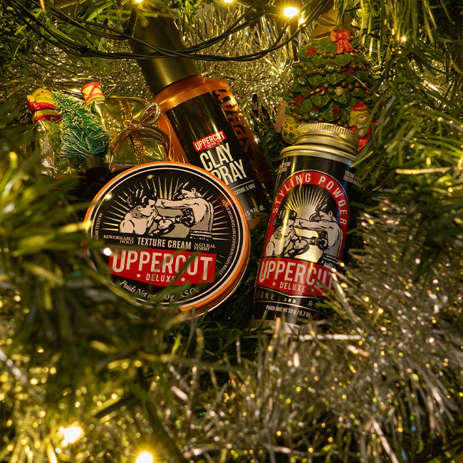 Uppercut Deluxe products placed inside a Christmas tree, surrounded by decorations and Christmas lights.