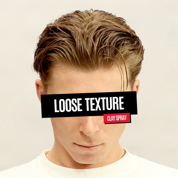 A man wearing a white crew-neck t-shirt, showcasing a styled, textured hairstyle with a side part. A black banner across his eyes reads 'LOOSE TEXTURE' and a small red badge reads 'CLAY SPRAY', indicating the product is a hair styling spray.